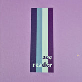 Bookmark with asexual flag and text that reads 'ace reader'.