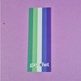 Bookmark with gay mlm flag and text that reads 'gay slut'.
