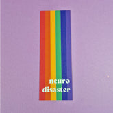 Bookmark with pride flag with text that reads 'neuro disaster'.