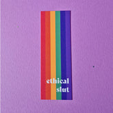 Bookmark with pride flag with text that reads 'ethical slut'.