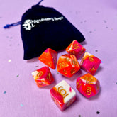 Set of lesbian: pink, orange and white dice with a velvet blue drawstring bag. A great gift to play dungeon and dragons with or any other ttrpg.