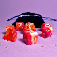 Set of lesbian: pink, orange and white dice with a velvet blue drawstring bag. A great gift to play dungeon and dragons with or any other ttrpg.