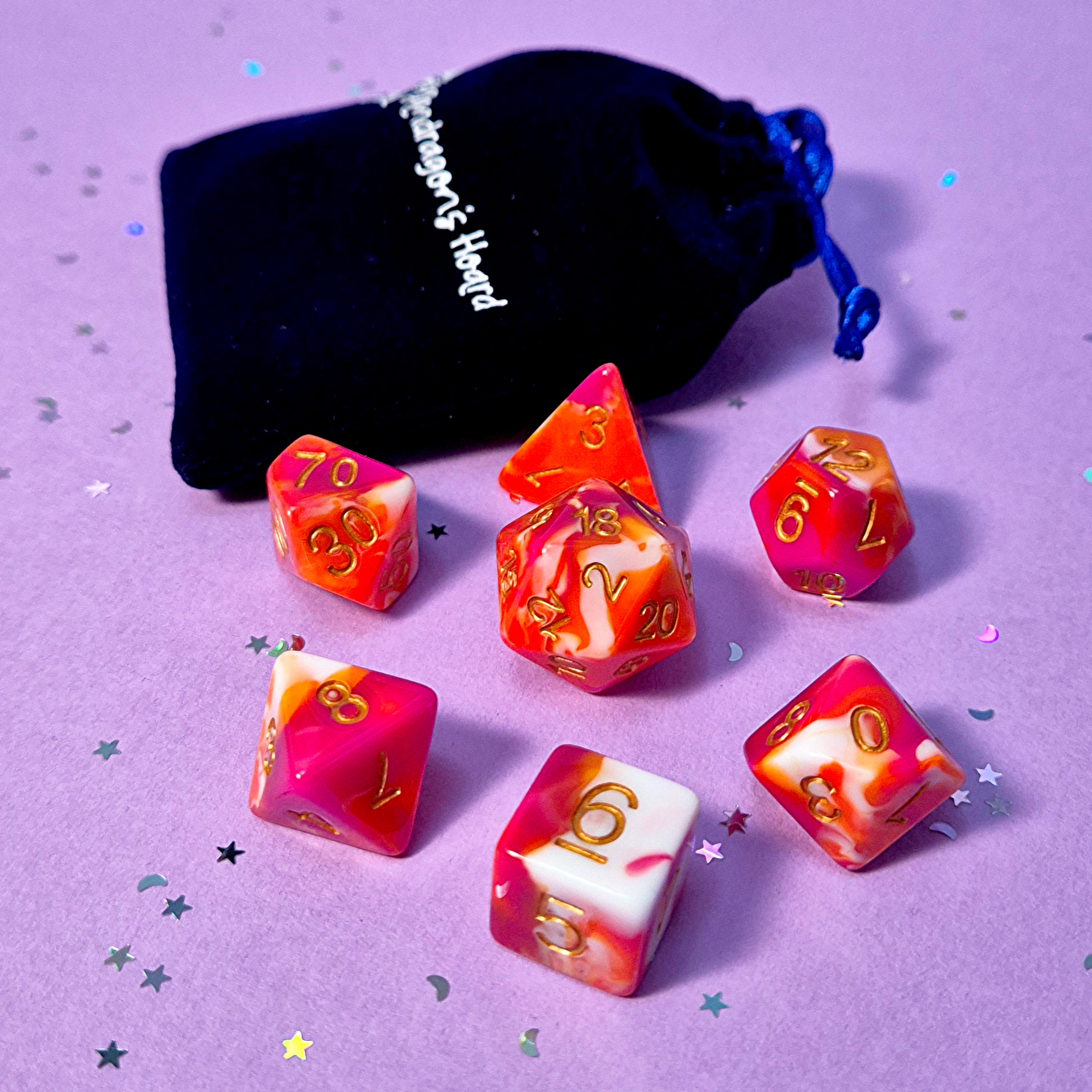 Set of lesbian: pink, orange and white dice with a velvet blue drawstring bag. A great gift to play dungeon and dragons with or any other ttrpg.