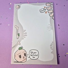 Memo pad with decorative border showing various skeleton and skulls. Top right has a spine that is cracking with 'Ow!' speech bubble coming from it. Bottom left has a skull with a small frog on it. Skull has speech buble saying 'Get your shit sorted luv,'