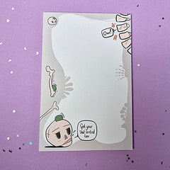 Memo pad with decorative border showing various skeleton and skulls. Top right has a spine that is cracking with 'Ow!' speech bubble coming from it. Bottom left has a skull with a small frog on it. Skull has speech buble saying 'Get your shit sorted luv,'