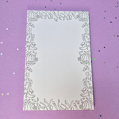 Memo pad with decorative border with a variety of sex toys on it; rabbit, dildo, anal beads, butt plug, vibrator and more